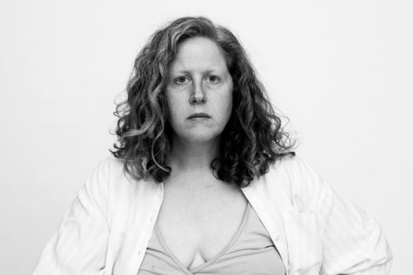 Black and white image of Jennifer staring directly to camera on white background