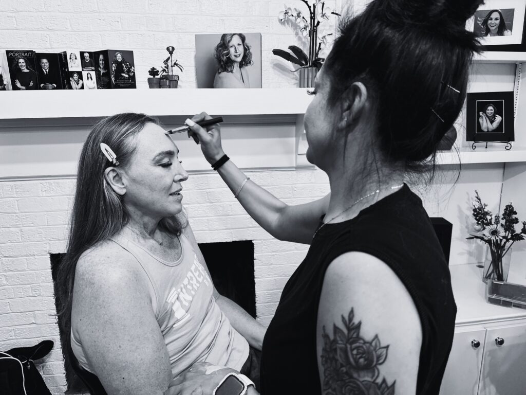 A woman enjoys professional hair and makeup at her branding experience session with Redhead Creative Media in Chapel Hill, NC.