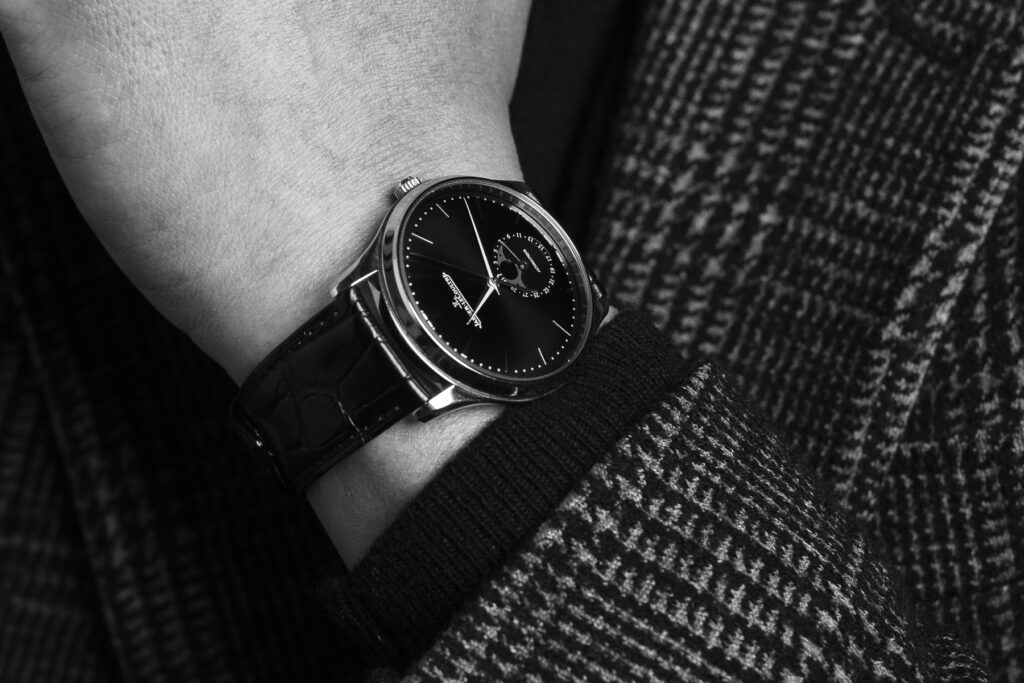 Close-up of watch worn on a wrist in combination with a plaid jacket from a brand experience session with Redhead Creative Media in Chapel Hill, NC.